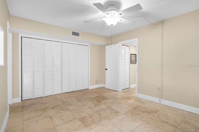 10033 64th Ave N Unit 4, Saint Petersburg, FL 33708 - unfurnished bedroom with a textured ceiling, ceiling fan, and a closet