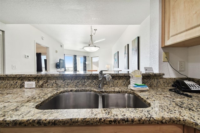 11605 Gulf Blvd Unit 402, Saint Petersburg, FL 33706 - kitchen with light stone countertops and pendant lighting