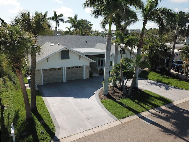 1837 Venetian Point Dr, Clearwater, FL 33755 - view of front facade featuring driveway, a garage, and stucco siding
