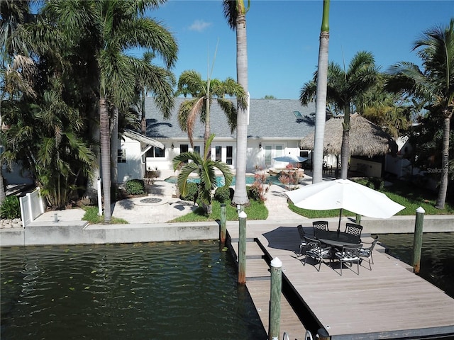 1837 Venetian Point Dr, Clearwater, FL 33755 - dock with a water view, a patio area, and an outdoor pool