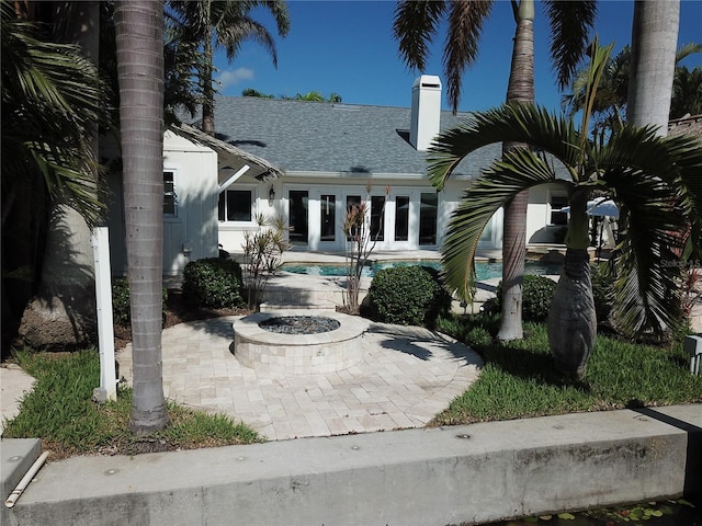 1837 Venetian Point Dr, Clearwater, FL 33755 - view of patio / terrace with an outdoor fire pit, an outdoor pool, and french doors