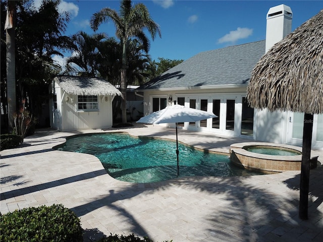 1837 Venetian Point Dr, Clearwater, FL 33755 - view of pool featuring a patio, an outdoor structure, and a pool with connected hot tub