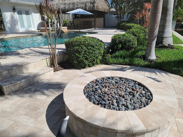 1837 Venetian Point Dr, Clearwater, FL 33755 - view of swimming pool with a fire pit, a patio area, and a pool with connected hot tub