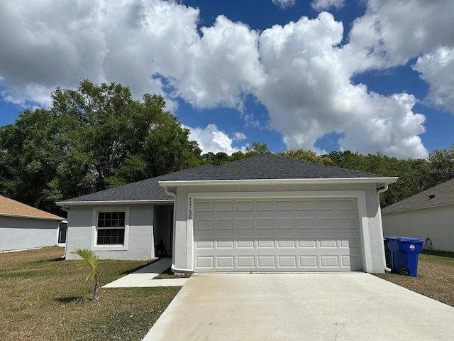 1737 N Lakewood Ave, Ocoee, FL 34761 - single story home with concrete driveway, stucco siding, an attached garage, and a front lawn