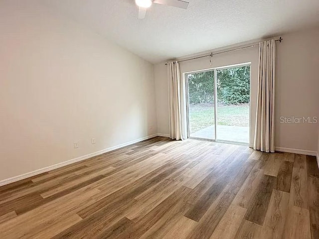 1737 N Lakewood Ave, Ocoee, FL 34761 - empty room with a ceiling fan, wood finished floors, and vaulted ceiling