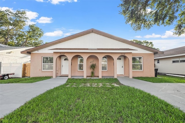7112 2nd St N, Saint Petersburg, FL 33702 - view of front of home featuring a front lawn, stucco siding, and a porch