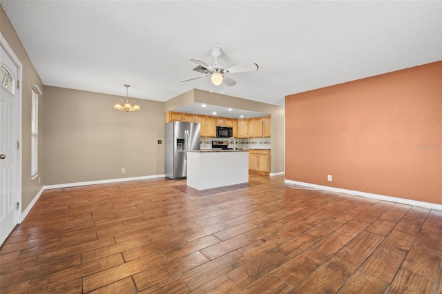 7112 2nd St N, Saint Petersburg, FL 33702 - unfurnished living room with light wood-style floors, ceiling fan, and a chandelier