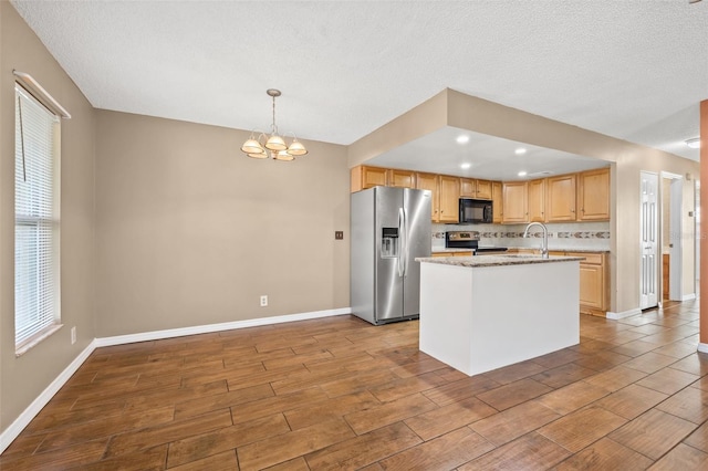 7112 2nd St N, Saint Petersburg, FL 33702 - kitchen with stainless steel appliances, dark wood-style flooring, a chandelier, tasteful backsplash, and an island with sink