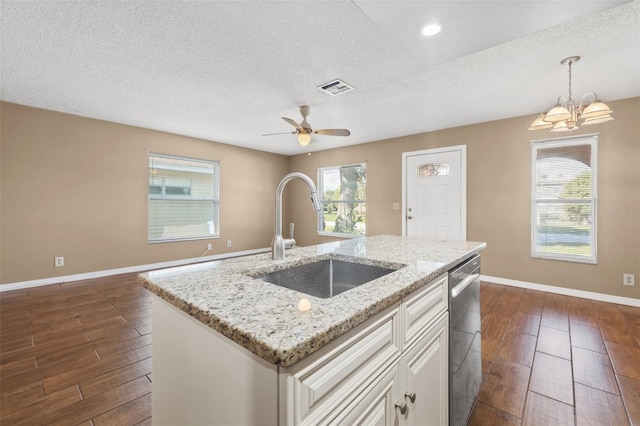 7112 2nd St N, Saint Petersburg, FL 33702 - kitchen featuring stainless steel dishwasher, dark wood finished floors, a textured ceiling, white cabinets, and light stone countertops