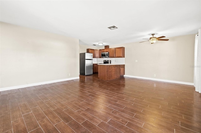 7112 2nd St N, Saint Petersburg, FL 33702 - unfurnished living room with dark wood-type flooring and ceiling fan