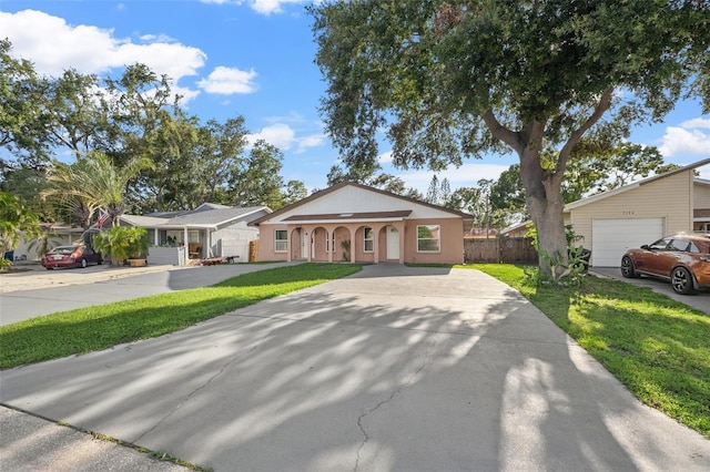 7112 2nd St N, Saint Petersburg, FL 33702 - view of front of house featuring driveway, a garage, and stucco siding