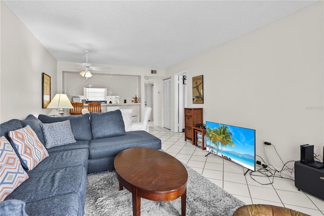 2625 State Road 590 Unit 723, Clearwater, FL 33759 - living room with light tile patterned floors, ceiling fan, and a textured ceiling