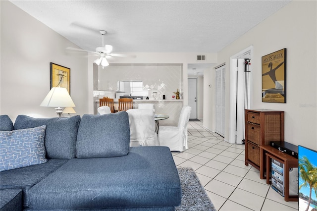 2625 State Road 590 Unit 723, Clearwater, FL 33759 - living area featuring light tile patterned floors, a ceiling fan, and a textured ceiling