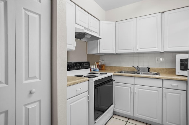 2625 State Road 590 Unit 723, Clearwater, FL 33759 - kitchen featuring white appliances, under cabinet range hood, light countertops, and white cabinets