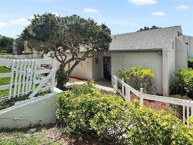 2625 State Road 590 Unit 723, Clearwater, FL 33759 - view of front of property with stucco siding and a shingled roof