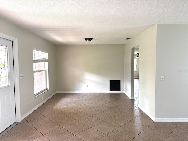 3645 E Country Side Dr, Inverness, FL 34452 - empty room featuring tile patterned floors and a textured ceiling