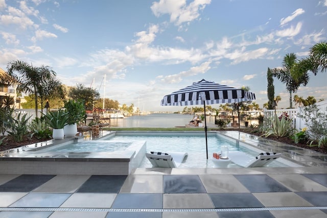 324 Capri Blvd, Treasure Island, FL 33706 - view of pool with a water view, a patio, and an in-ground hot tub