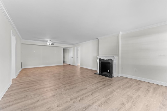 4313 W N A St, Tampa, FL 33609 - unfurnished living room with a premium fireplace, light wood-style flooring, and ornamental molding
