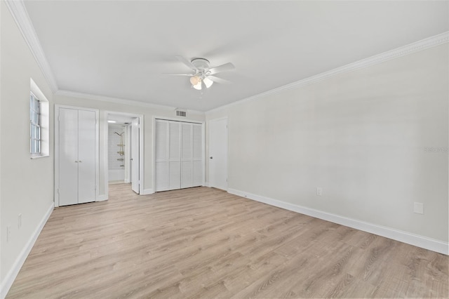 4313 W N A St, Tampa, FL 33609 - unfurnished bedroom featuring light wood-style floors, crown molding, ceiling fan, and two closets