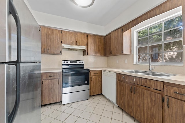 4313 W N A St, Tampa, FL 33609 - kitchen with stainless steel appliances, under cabinet range hood, light tile patterned flooring, and light countertops