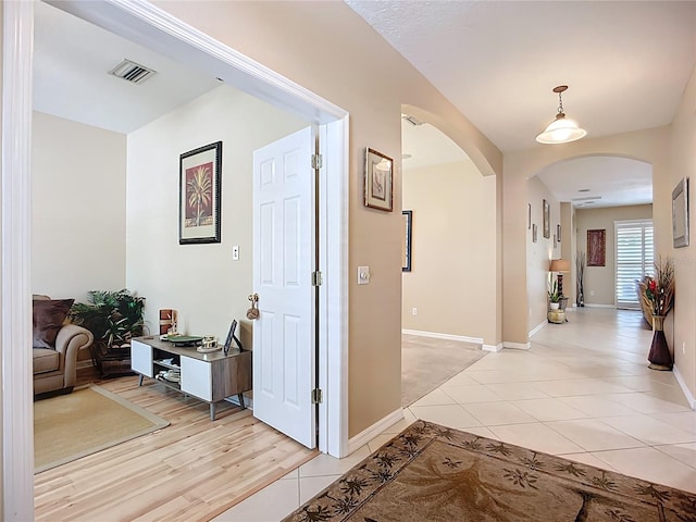 3409 61st Ter E, Ellenton, FL 34222 - corridor with arched walkways and light tile patterned flooring