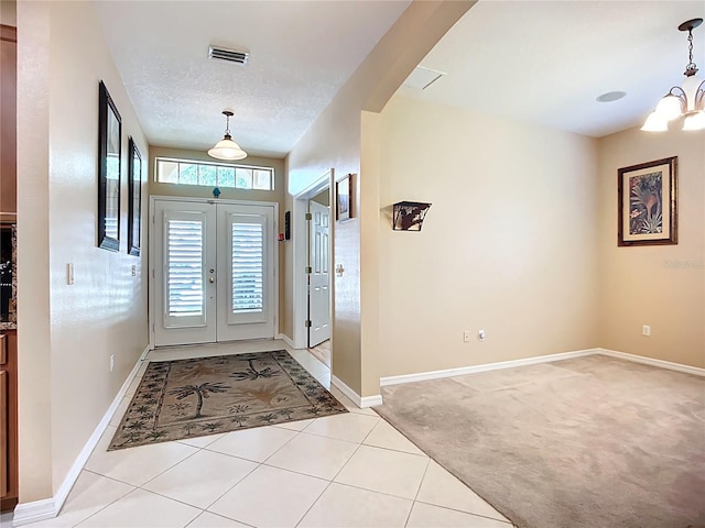 3409 61st Ter E, Ellenton, FL 34222 - entryway featuring a chandelier, light tile patterned floors, and light carpet