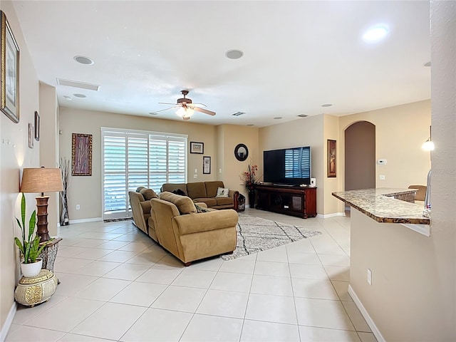 3409 61st Ter E, Ellenton, FL 34222 - living room with arched walkways, a ceiling fan, and light tile patterned flooring