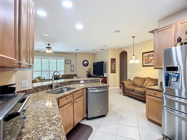 3409 61st Ter E, Ellenton, FL 34222 - kitchen with appliances with stainless steel finishes, open floor plan, arched walkways, a peninsula, and light tile patterned flooring