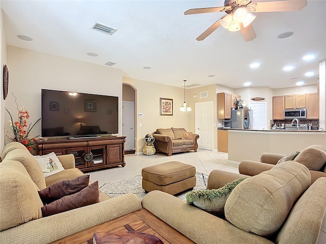 3409 61st Ter E, Ellenton, FL 34222 - living area featuring arched walkways, ceiling fan, and light tile patterned floors