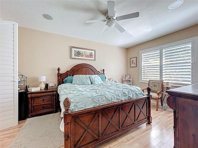 3409 61st Ter E, Ellenton, FL 34222 - bedroom featuring a textured ceiling, light wood-style flooring, and ceiling fan