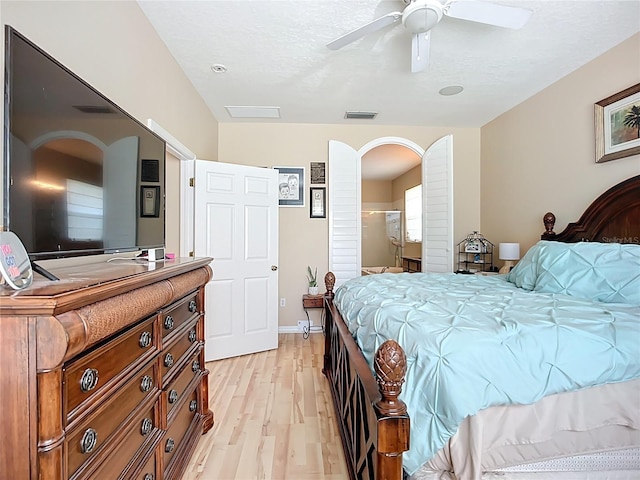 3409 61st Ter E, Ellenton, FL 34222 - bedroom featuring arched walkways, light wood-type flooring, and a ceiling fan