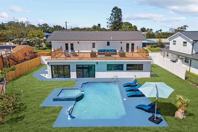 380 Colony Point Rd S, Saint Petersburg, FL 33705 - back of property with french doors, stucco siding, a fenced backyard, and a metal roof