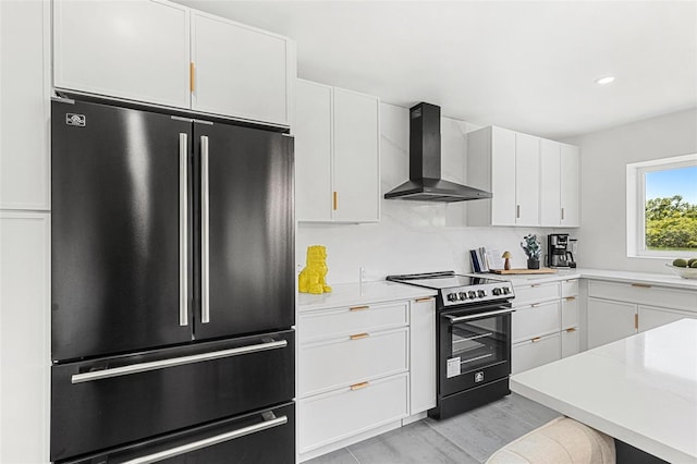 380 Colony Point Rd S, Saint Petersburg, FL 33705 - kitchen featuring freestanding refrigerator, range with electric stovetop, wall chimney exhaust hood, white cabinets, and light countertops