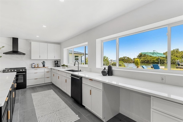 380 Colony Point Rd S, Saint Petersburg, FL 33705 - kitchen with wall chimney exhaust hood, gas range oven, dishwasher, white cabinetry, and recessed lighting