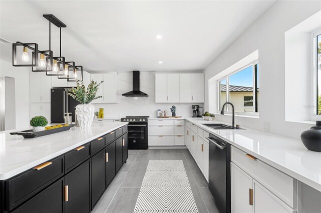 380 Colony Point Rd S, Saint Petersburg, FL 33705 - kitchen with wall chimney exhaust hood, stainless steel gas stove, dark cabinetry, dishwashing machine, and white cabinetry