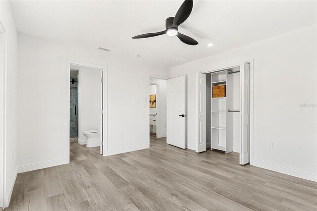 380 Colony Point Rd S, Saint Petersburg, FL 33705 - unfurnished bedroom featuring light wood finished floors, recessed lighting, a closet, a ceiling fan, and ensuite bath