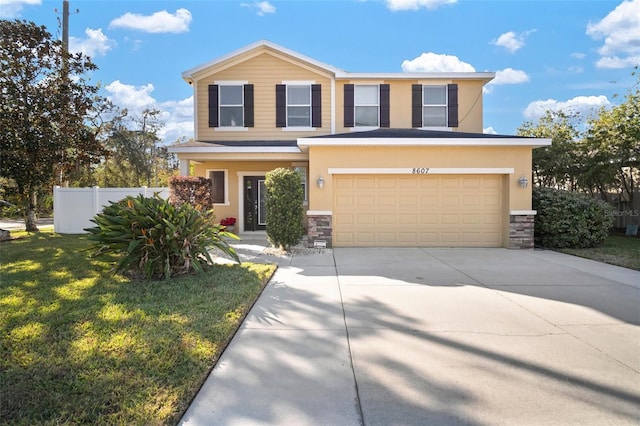 8607 Tidal Breeze Dr, Riverview, FL 33569 - view of front facade with stone siding, driveway, a garage, and stucco siding