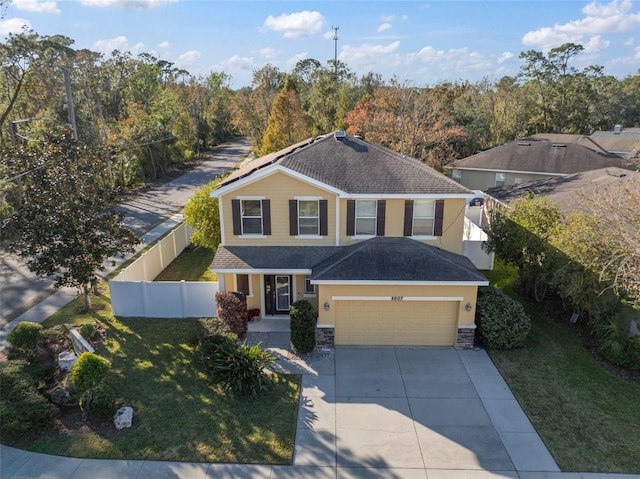 8607 Tidal Breeze Dr, Riverview, FL 33569 - view of front of property featuring driveway, a garage, a shingled roof, stucco siding, and stone siding