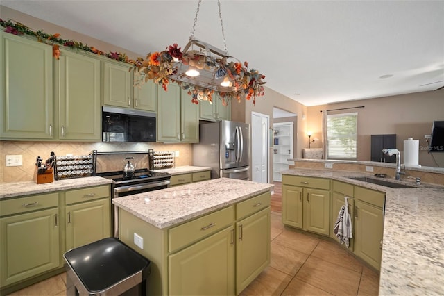8607 Tidal Breeze Dr, Riverview, FL 33569 - kitchen featuring stainless steel appliances, green cabinets, backsplash, and a kitchen island