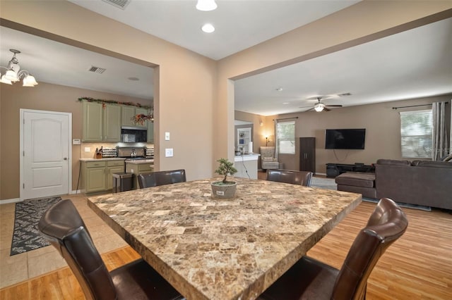 8607 Tidal Breeze Dr, Riverview, FL 33569 - dining area featuring a chandelier, ceiling fan, light tile patterned flooring, and recessed lighting