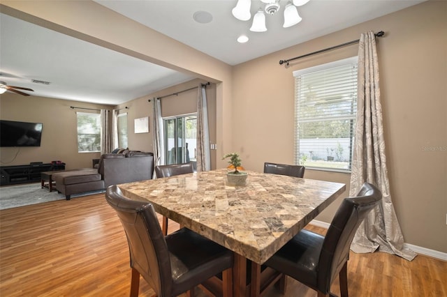 8607 Tidal Breeze Dr, Riverview, FL 33569 - dining space featuring a ceiling fan, light wood-style floors, and a chandelier
