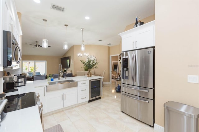 11913 Butler Woods Cir, Riverview, FL 33579 - kitchen with appliances with stainless steel finishes, wine cooler, light countertops, a peninsula, and recessed lighting