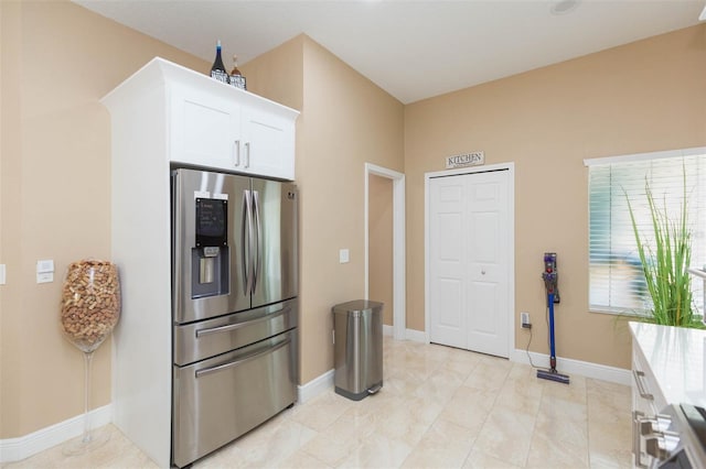 11913 Butler Woods Cir, Riverview, FL 33579 - kitchen with stainless steel fridge, white cabinetry, and light countertops