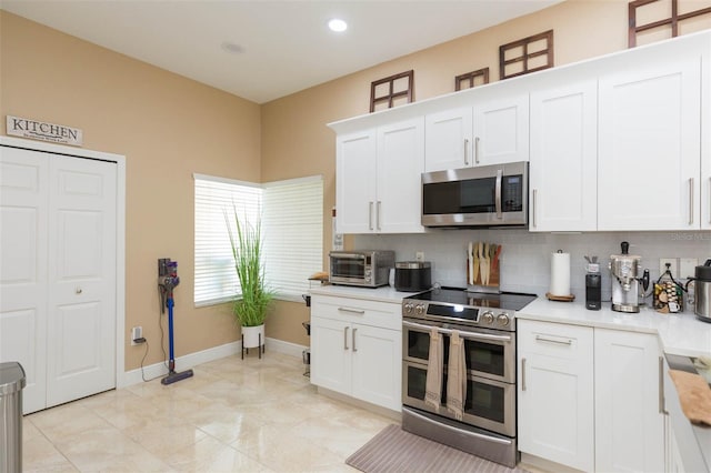 11913 Butler Woods Cir, Riverview, FL 33579 - kitchen with stainless steel appliances, light countertops, tasteful backsplash, white cabinetry, and recessed lighting