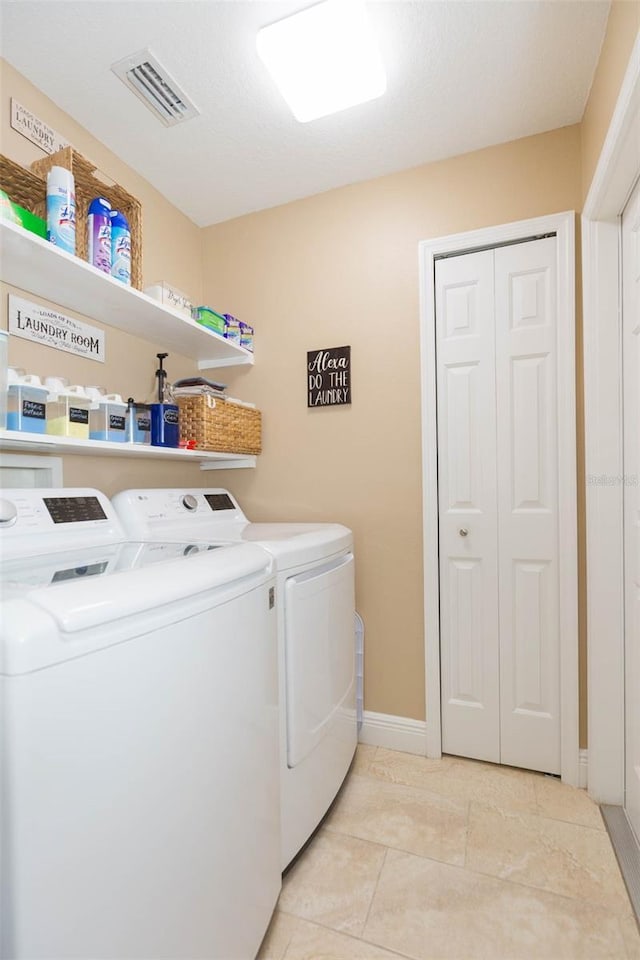 11913 Butler Woods Cir, Riverview, FL 33579 - laundry room with washer and dryer and light tile patterned flooring