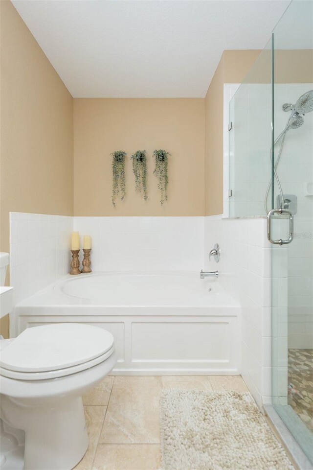 11913 Butler Woods Cir, Riverview, FL 33579 - bathroom featuring a bath, a shower stall, and tile patterned floors