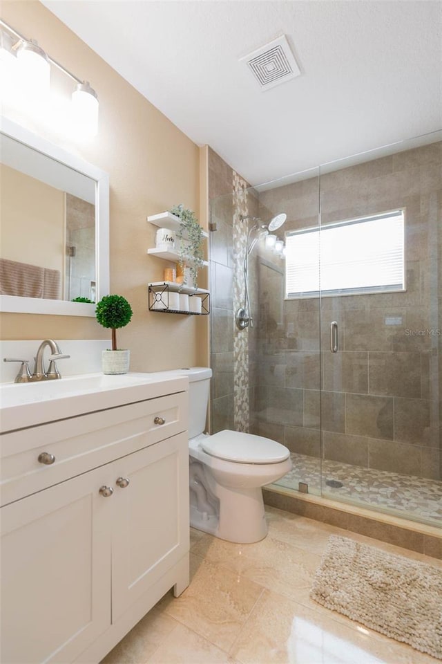 11913 Butler Woods Cir, Riverview, FL 33579 - bathroom featuring vanity, a shower stall, and tile patterned flooring