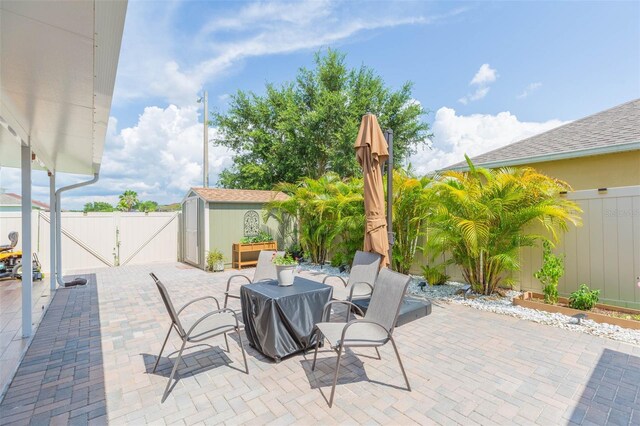 11913 Butler Woods Cir, Riverview, FL 33579 - fenced backyard with a gate, a patio, a shed, and outdoor dining area