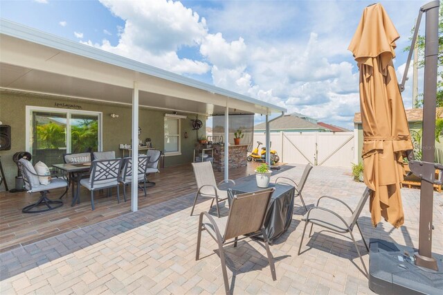 11913 Butler Woods Cir, Riverview, FL 33579 - view of patio / terrace with outdoor dining area and a gate