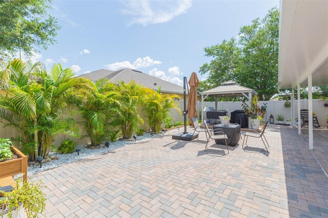 11913 Butler Woods Cir, Riverview, FL 33579 - fenced backyard with a gazebo and a patio